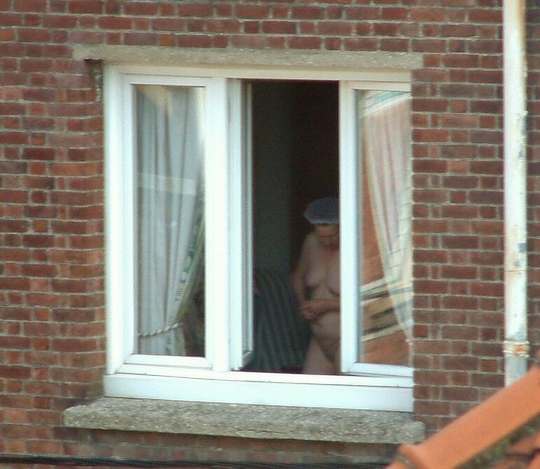 Free porn pics of Voyeur : My old Neighboor naked at the window ! 4 of 25 pics