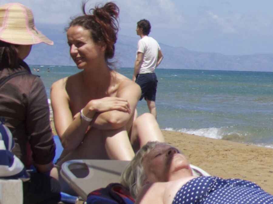 Free porn pics of Girl with a bun caught topless in Agia Marina, Creta. 7 of 18 pics