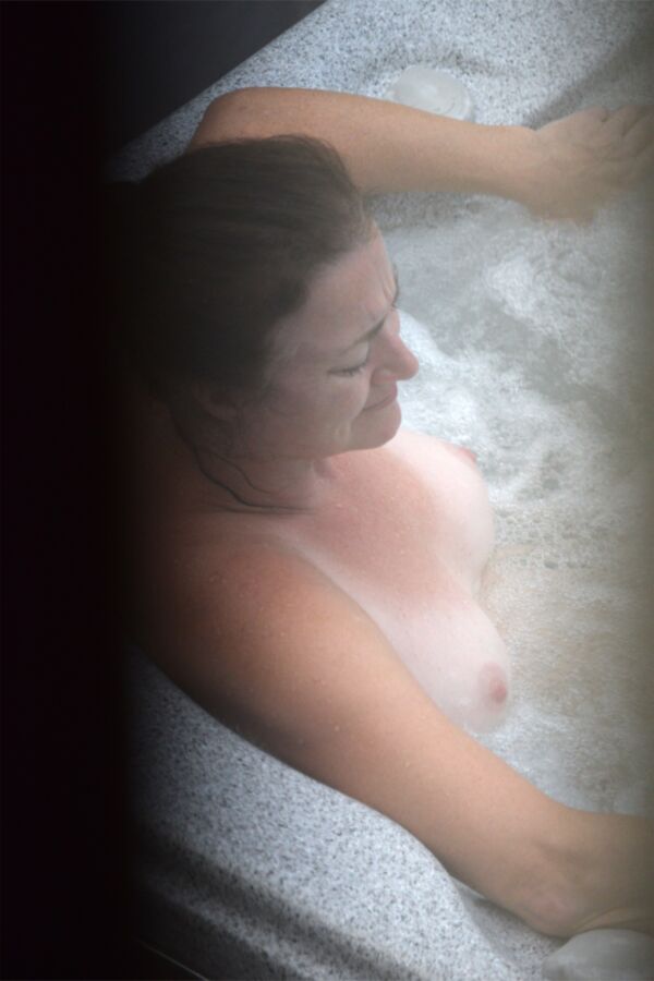 Free porn pics of Voyeur mature brunette big tits in hot tub window 2 of 5 pics